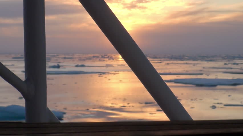 Sunset in the ocean among the icebergs and ice in the Arctic. Fantastic wonderful amazing video grenland nature iceland. Lovely shooting the life of nature, seaside and mountains. Global warming.