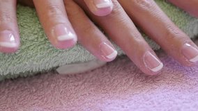 Slow motion French manicure on woman hand 1080p HD footage - Doing nail manicure in professional salon close-up slow-mo 1920X1080 FullHD video