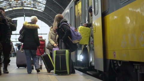 PRAGUE, CZECH REPUBLIC - CIRCA DECEMBER, 2015: Passengers at railway station. Slowmotion video of people coming out from modern train, traveling, tourism