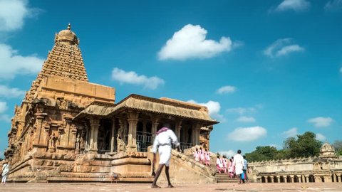 Thanjavur - February 2016: Time lapse of people visiting Brihadeshwara Temple with blue sky and fast moving clouds. 4K resolution.