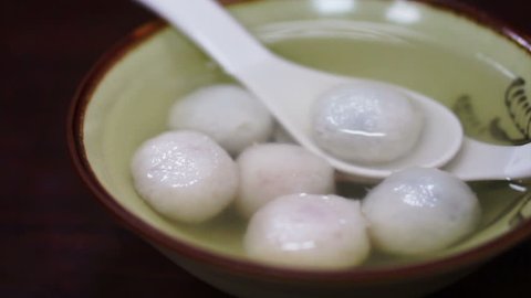 Chinese traditional dessert, rice flour stuffed with sesame inside Stock Video