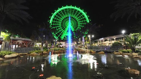 Time-lapse of 'The Orlando Eye' with a colored fountain in front. It is the largest observation wheel on the East Coast of Florida and located on International Drive in Orlando.