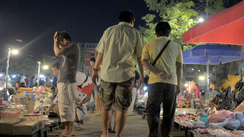 BANGKOK, THAILAND - NOVEMBER 2011: People browse and shop at a night market