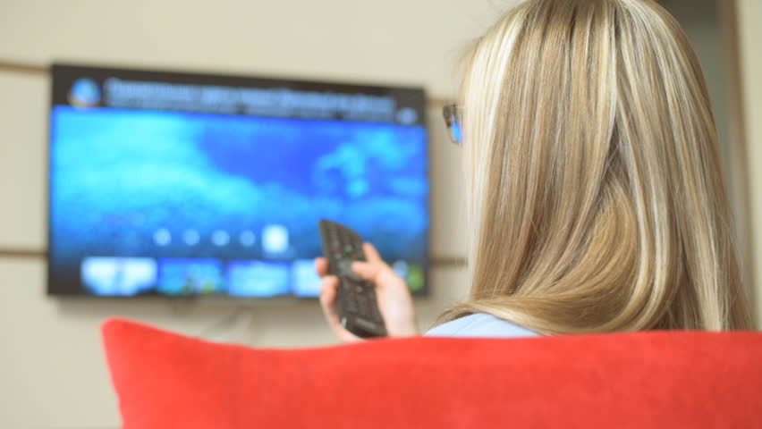 Female watching tv and laughing
