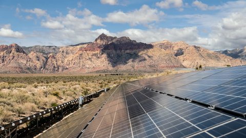 Solar energy panels with Mojave desert clouds time lapse at Red Rock Canyon National Conservation Area in Southern Nevada.