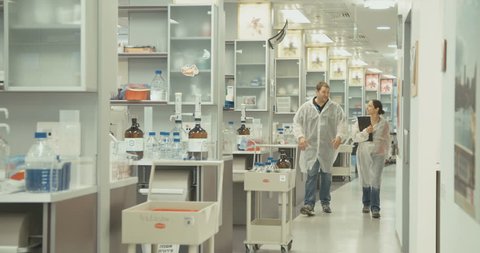 Scientists walking in a pharmaceutical lab