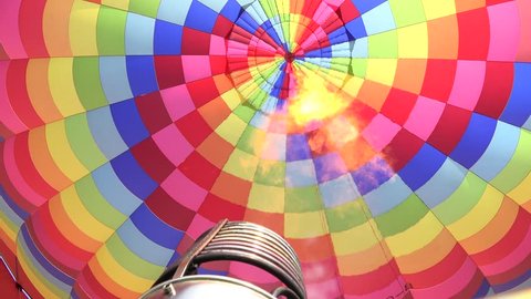 Activating the propane burner, Interior of a hot air balloon, burners are located directing the jet of fire toward the entrance of the envelope. 4K