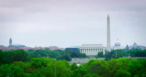 Washington DC Monuments Timelapse Wide Shot Cloudy Spring Day with green trees. The Old Post Office/Trump Hotel, Lincoln, Washington, US Capitol. Use the 4K to do a digital zoom. Available in HDR.