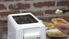 Slow motion video of buttering hot toast

