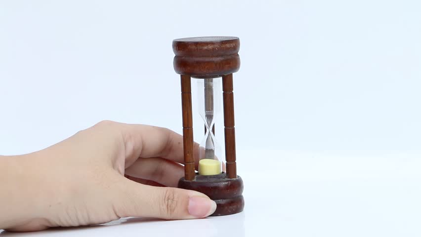 hand holding hourglass on white background