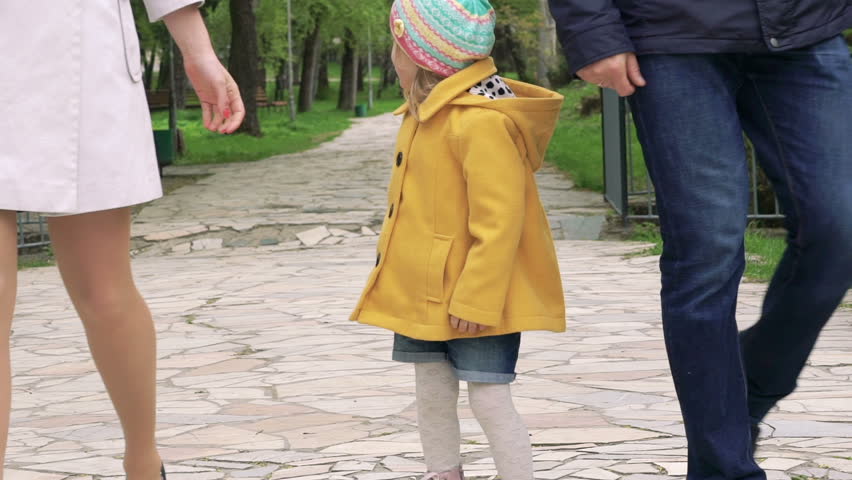 Little girl turning and running away in the park. Slowly