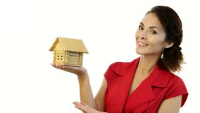 Home - new house concept. Woman holding wooden toy model house against isolated white backgroung in studio 