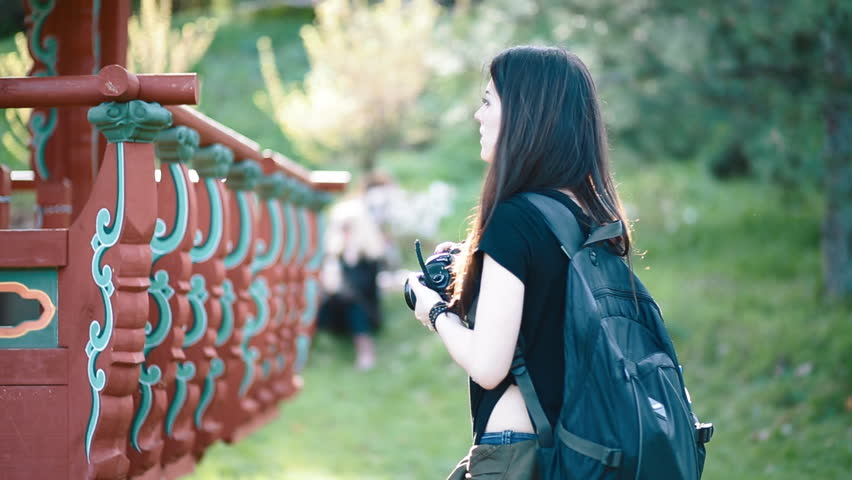Young woman photographer work with model outdoor. Backstage.