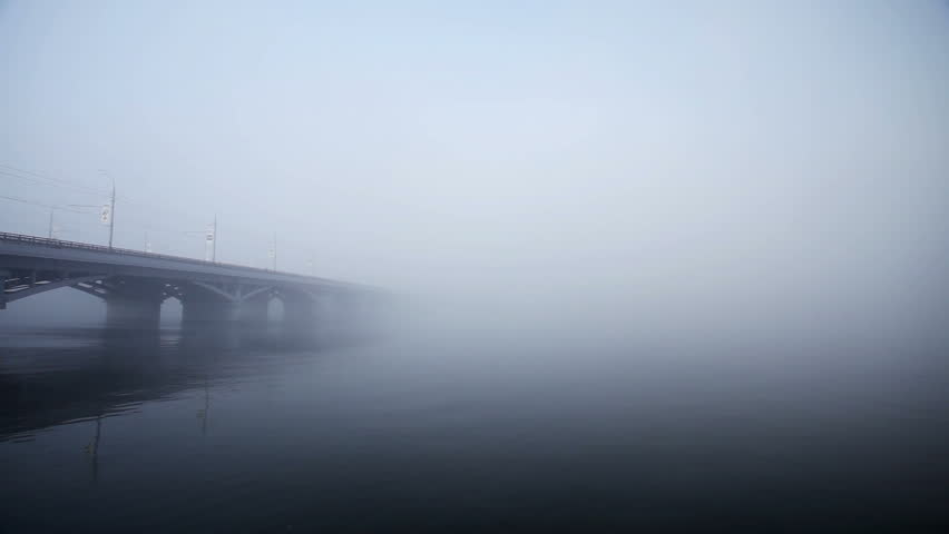 Urban landscape. Breathtaking view of the bridge in thick fog.