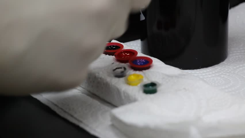 The artist takes the tattoo ink