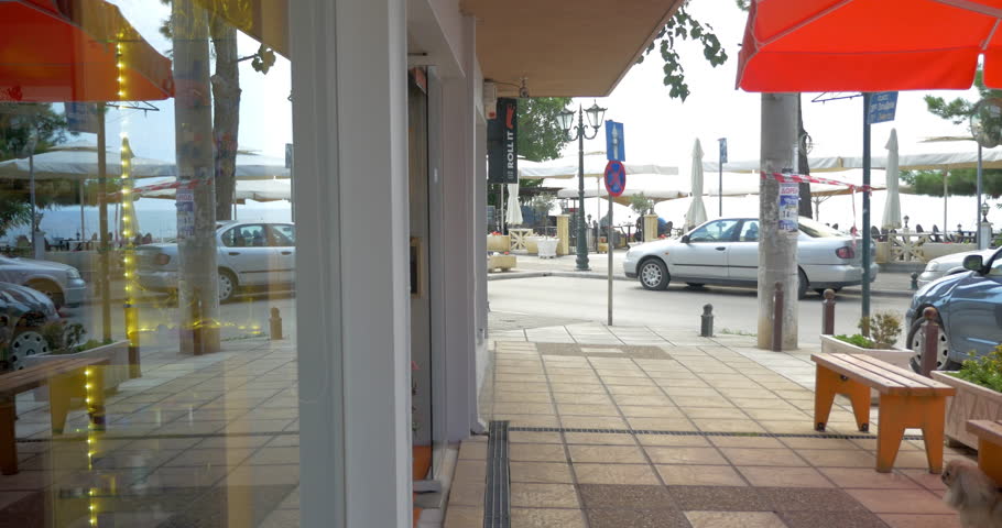 Parents and little son walking out of the shop and making the way on city street