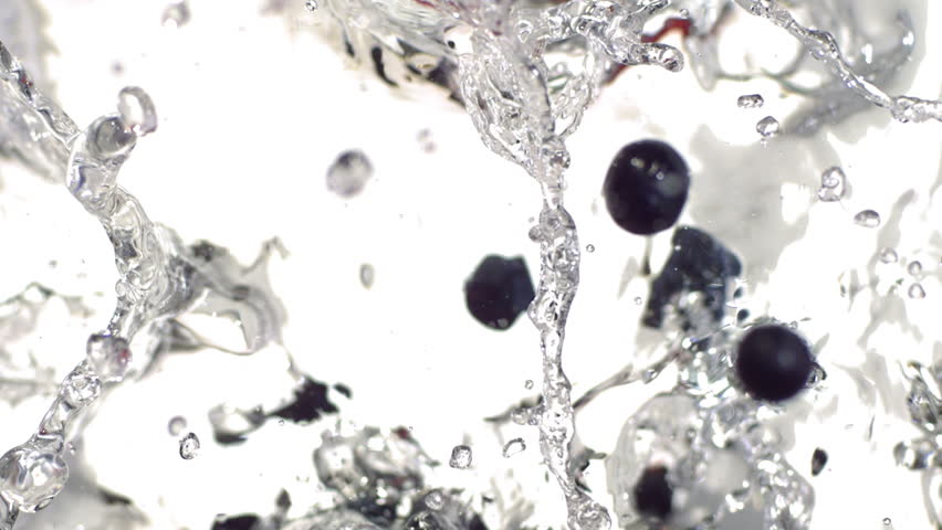 fruits falling in to the water from above in slow motion