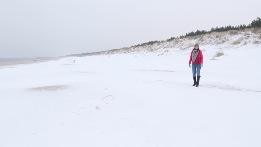 Couple e having so much fun on a beach, girl running and jumping at her boyfriend hugging him and turning in circles. Gimbal stabilized camera movement .