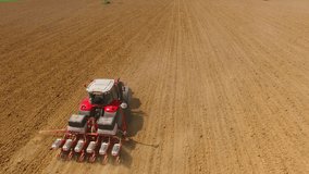 Camera flight over ploughed field with tractor. Industry and Agriculture in Czech Republic, European Union.