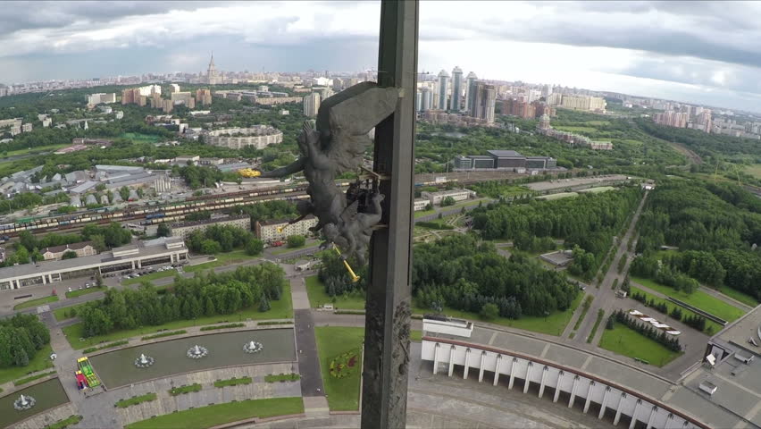Aerial shot of Victory Monument established in Victory Park on Poklonnaya Hill.  Obelisk 141,8 meters height with  Nika sculpture on city background