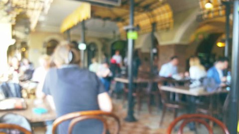 People in restaurant interior, blurred background