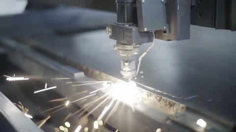 Cut sheet metal at workshop. Modern tool in heavy industry. Dangerous job. High precision manufacture of steel parts. Automation of process indoors. Automatic work for ironwork. Close up computer cnc