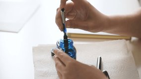 Female writer filling luxury old fountain pen with golden nib with exclusive blue ink from glass bottle - Powered by Shutterstock - Get 15% off with code: PIKWIZARD15