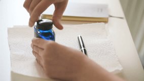 Female writer opening bootle ink to fill the luxury old fountain pen with golden nib - Powered by Shutterstock - Get 15% off with code: PIKWIZARD15