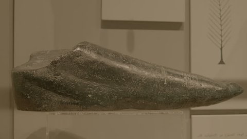 Bahrain National Museum, Bahrain - circa 2011 - MCU on piece of black basalt (possibly foot of a statue) carved with a feather and cuneiform writing from the Sumerian collection.
