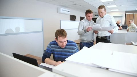 group of people are busy working in the office