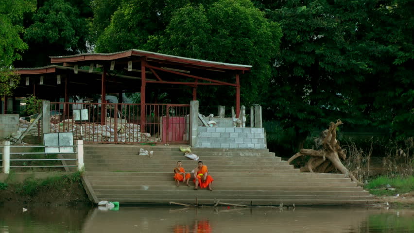 CHIANG MAI, THAILAND - CIRCA OCTOBER 2011 -  Monks survey the damage caused by