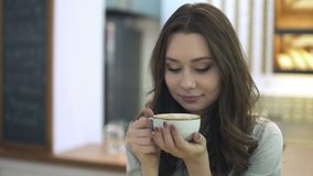 Woman smelling coffee in cafe
