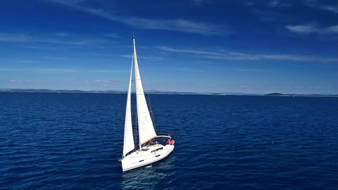 Yacht sailing on open sea at sunny day. Yachting. Yacht video. Yacht drone video. Sailing video. Sailing boat. Sailing aerial video. Sailing yacht.