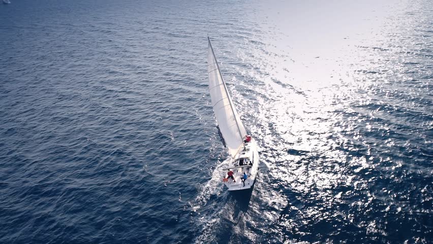 Yacht sailing on opened sea. Sailing boat. Yacht from drone. Yachting video. Yacht from above. Sailboat from drone. Sailing video. Yachting at windy day. Yacht. Sailboat.