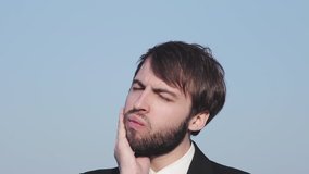 Young man businessman emotes. In the frame head, beard and shoulders