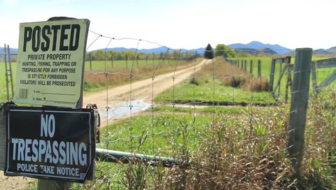 "No Trespassing" signs in front of vast country property
