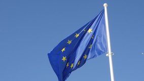 Blue yellow with stars European Union flag waving on wind in slow motion 1920X1080 HD footage - Eu flag in front of blue sky hanging on flagpole 1080p FullHD slow-mo  video