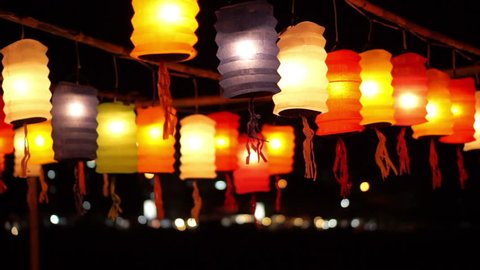 Thai style Lanna flag and Paper lanterns decorated by the river in Yee-peng festival ,ChiangMai Thailand Video de stock