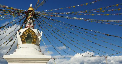 4k buddhist white stupa & flying prayer flags with blue sky background,shangrila yunnan,china. gh2_10476_4k
