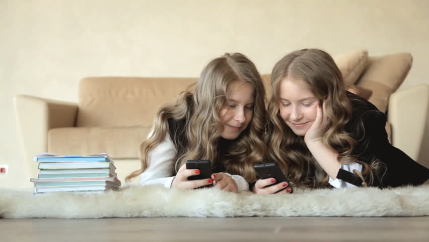 sisters twins examine messages phone Stock Footage Video (100% Royalty-free...