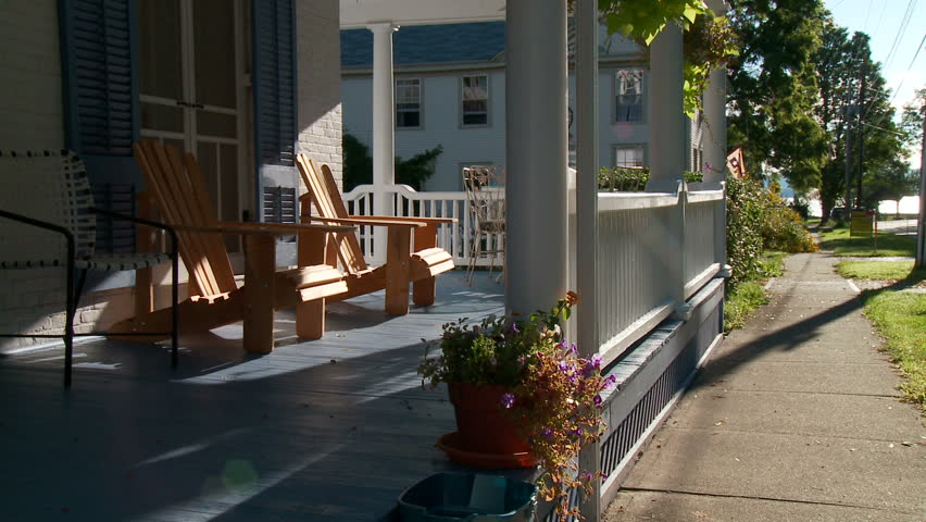 Empty chairs on porch in morning