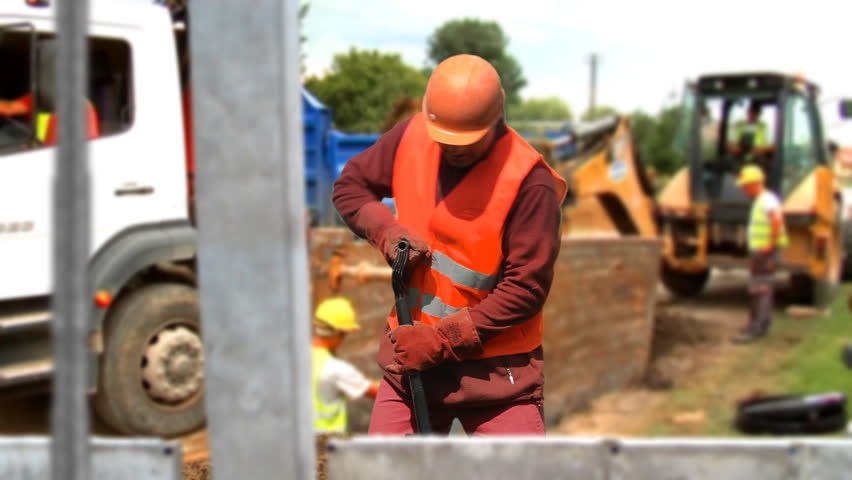 Back strain from overexertion during manual labor on a construction site. Royalty-Free Stock Footage #16641466