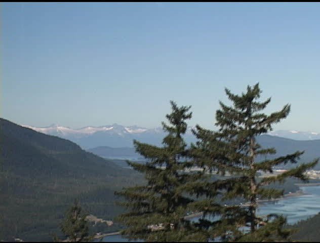 Alaskan Mountain range shot from cable car traveling up Mr. Roberts in Juneau, Alaska with airport in the distance.