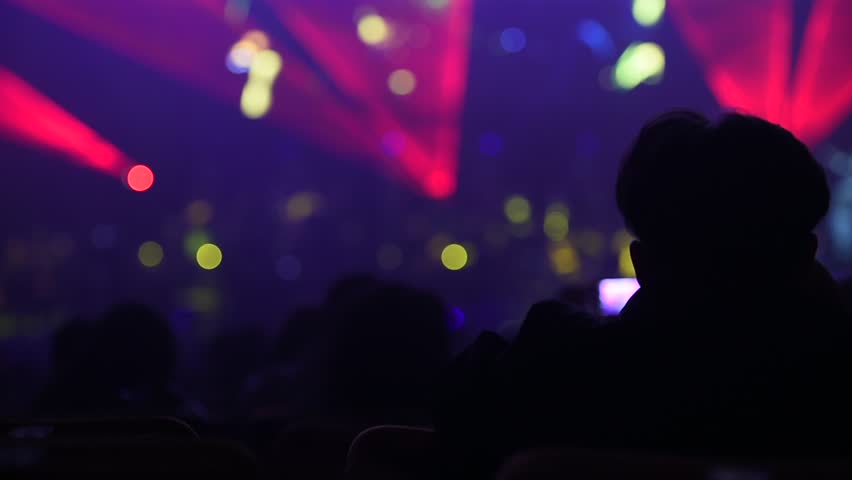 Unrecognizable people watching a beautiful laser show with multicolored lights | Shutterstock HD Video #16646488