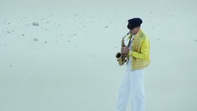 Saxophonist. Actor in a scenic suit playing in the sand pit. Video Series