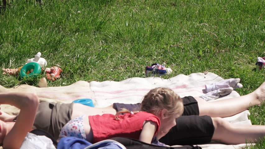 On carpet is mother and daughter playing with her