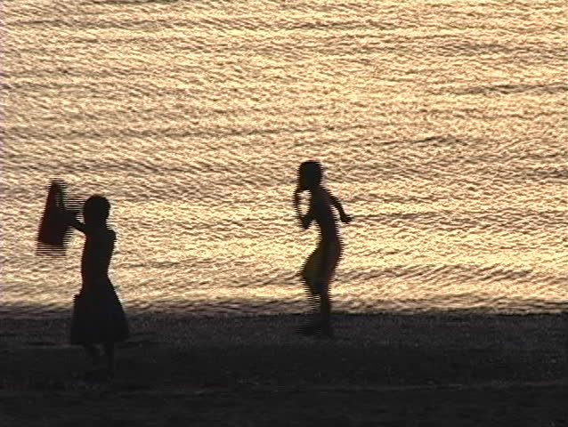 Silhouette of Filipino children playing on the beach