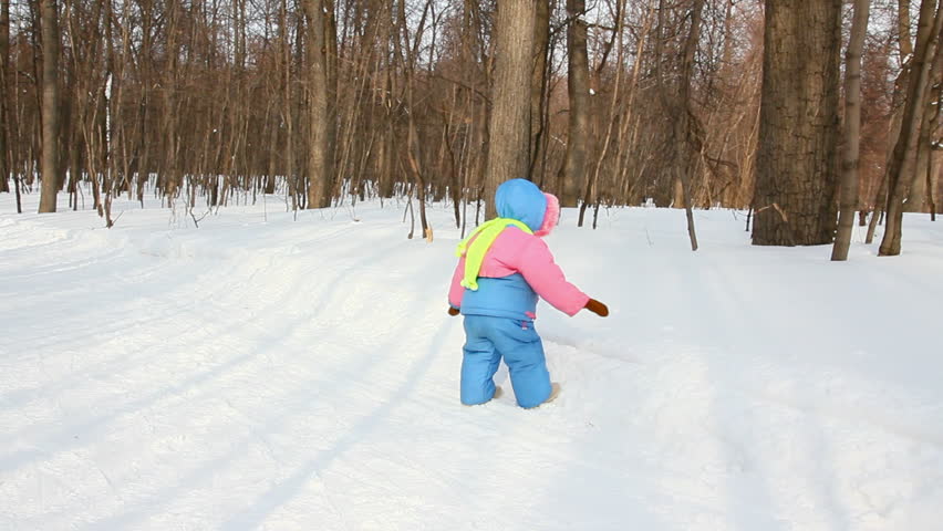 baby girl walking in winter park