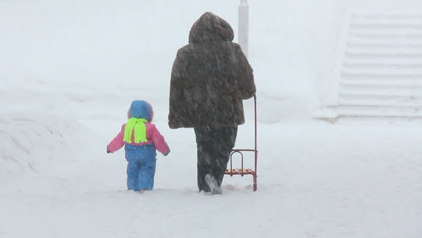 mother and child walking at winter