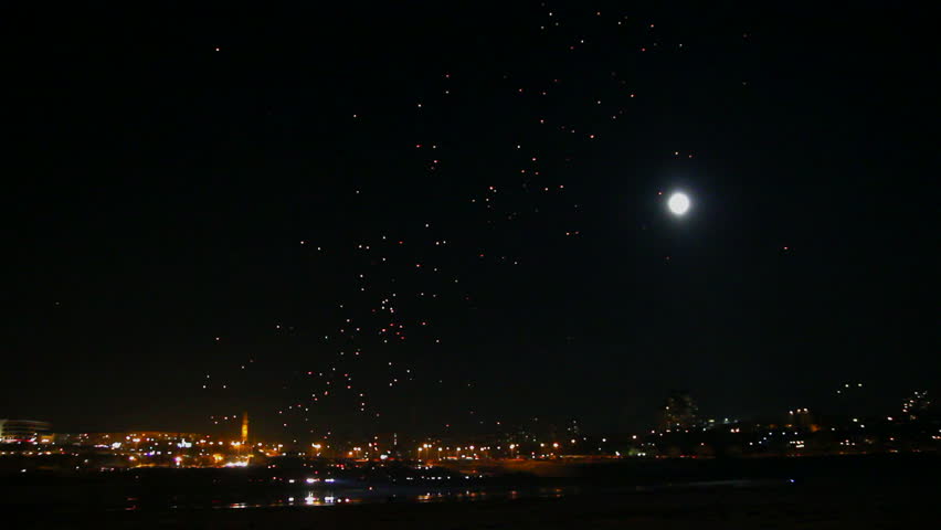 many Japanese Lantern flies over city at night - timelapse